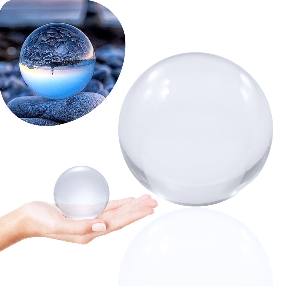 65mm Clear Contact Juggling Ball; Contact Ball lying in Hand; Close-up of ball standing on stones; Inverted panorama of seaside in reflection of ball.