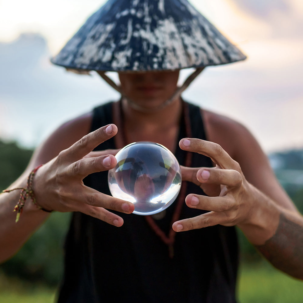 Man holding Acrylic Contact Ball between fingers in blurred nature background