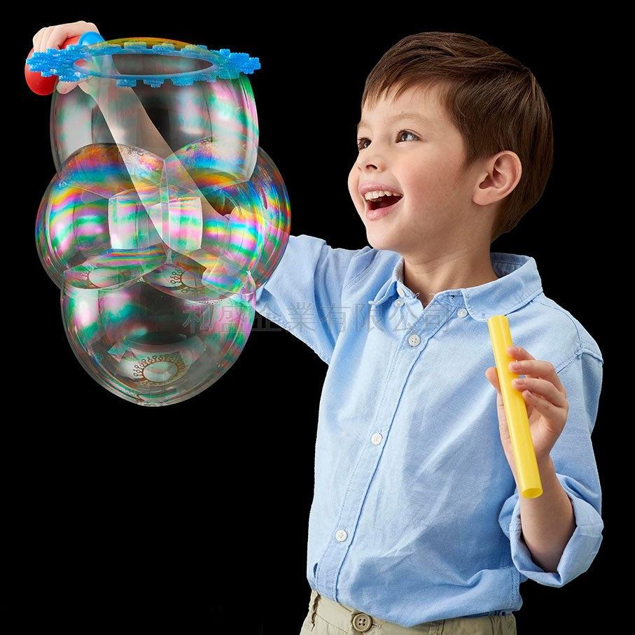 Boy playing with bubble kit making bubble flower