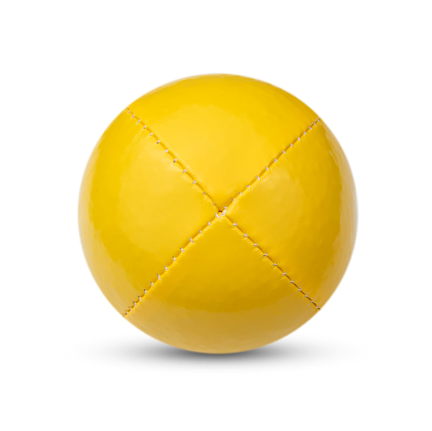 A yellow Juggle Dream 120g thud juggling ball