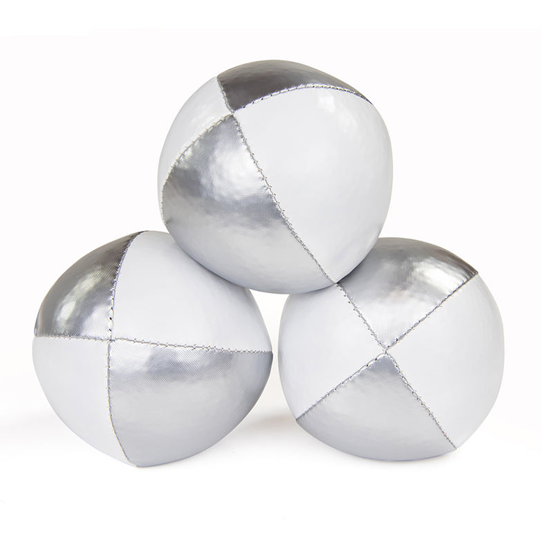One ball on top of other two juggling balls - silver/ white colours