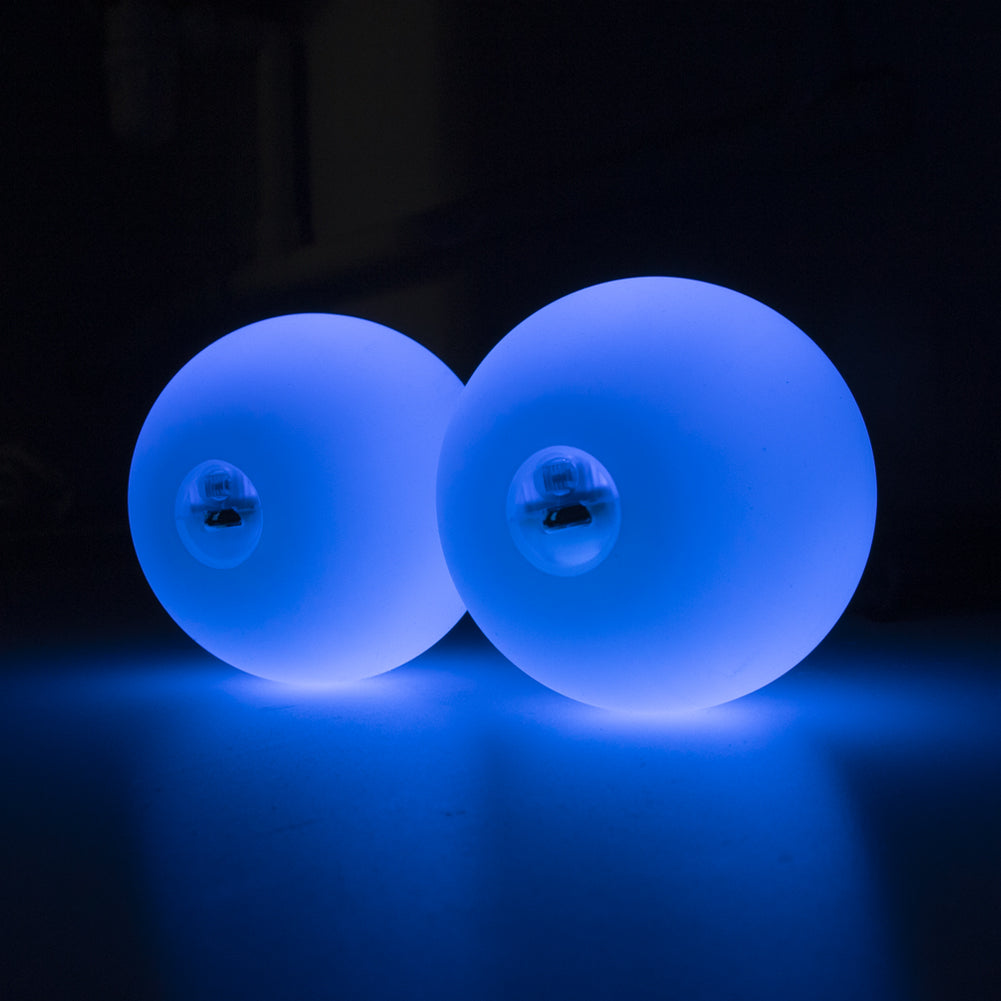 A pair of 70mm Multi function Pro Poi glowing in purple colour; view from the side