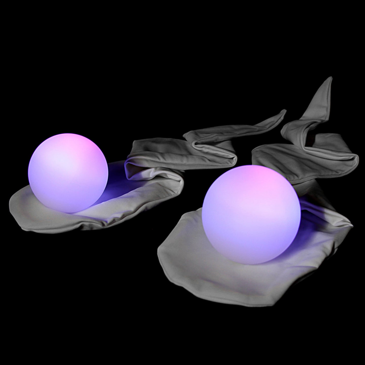 Purple LED Fade Balls lying on Socks