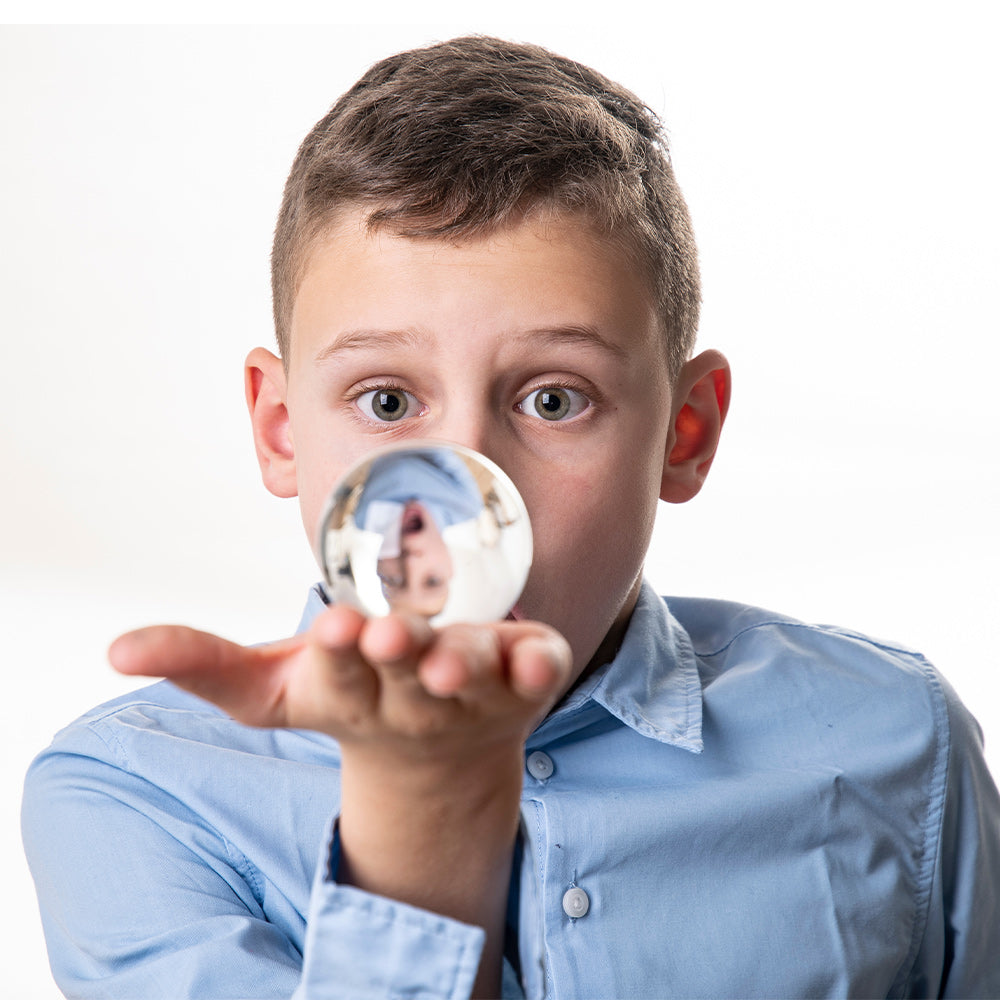 Boy holding an acrylic contact ball in hand
