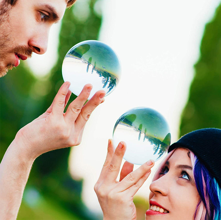 A guy and a girl holdig Crystal Clear Contact Juggling Balls in Hands