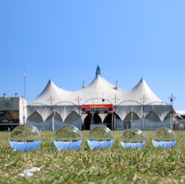 All sizes Juggle Dream Crystal Clear Contact Juggling Balls on the grass with circus tent background