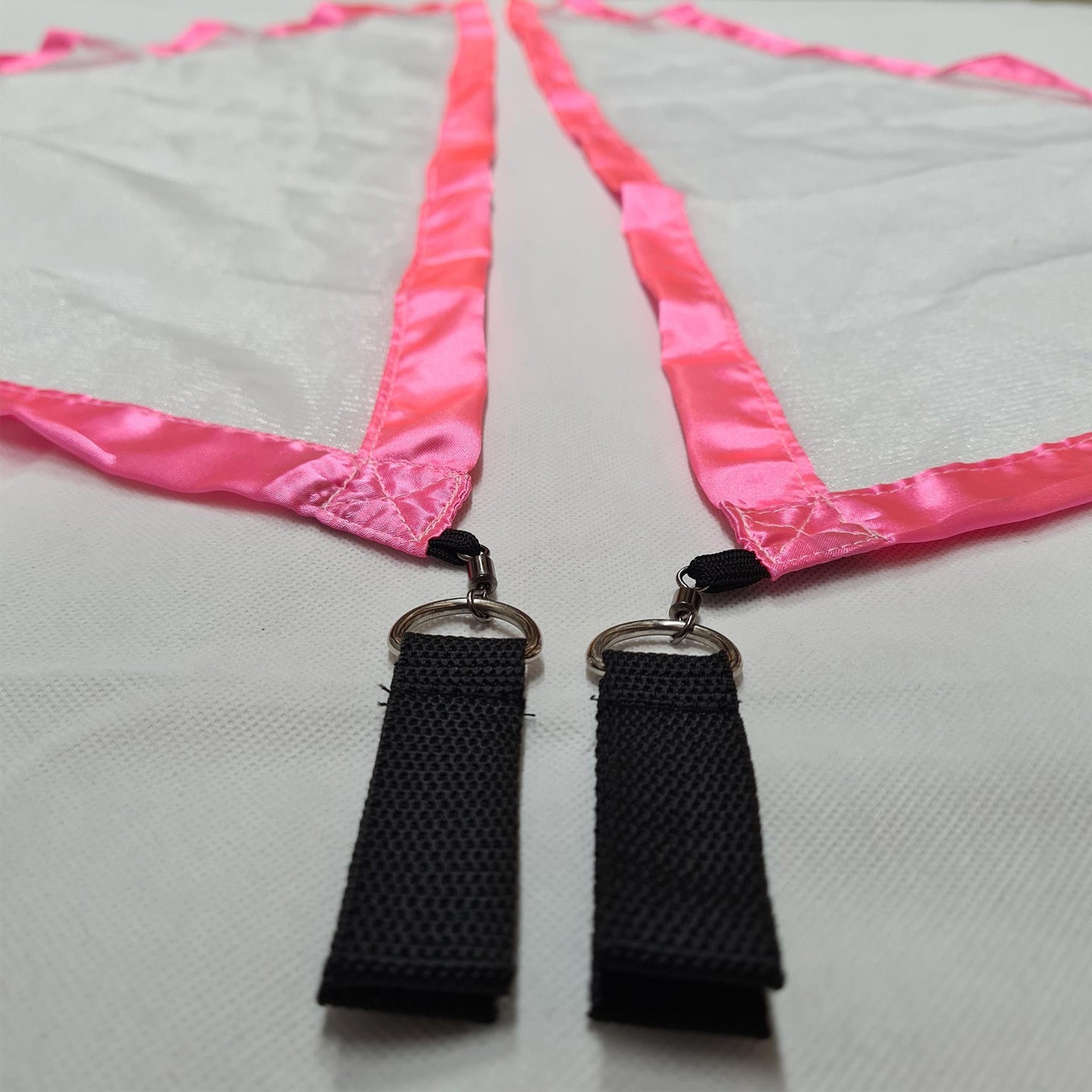 Close-up of white/pink Flag Poi nylon handles