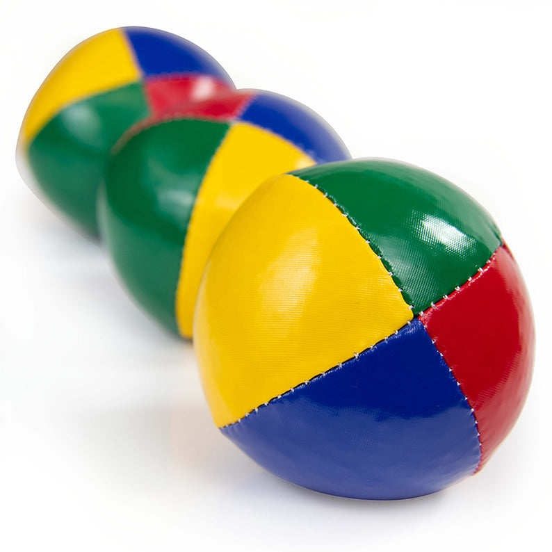 Three beach juggling balls from big focused to smaller faded