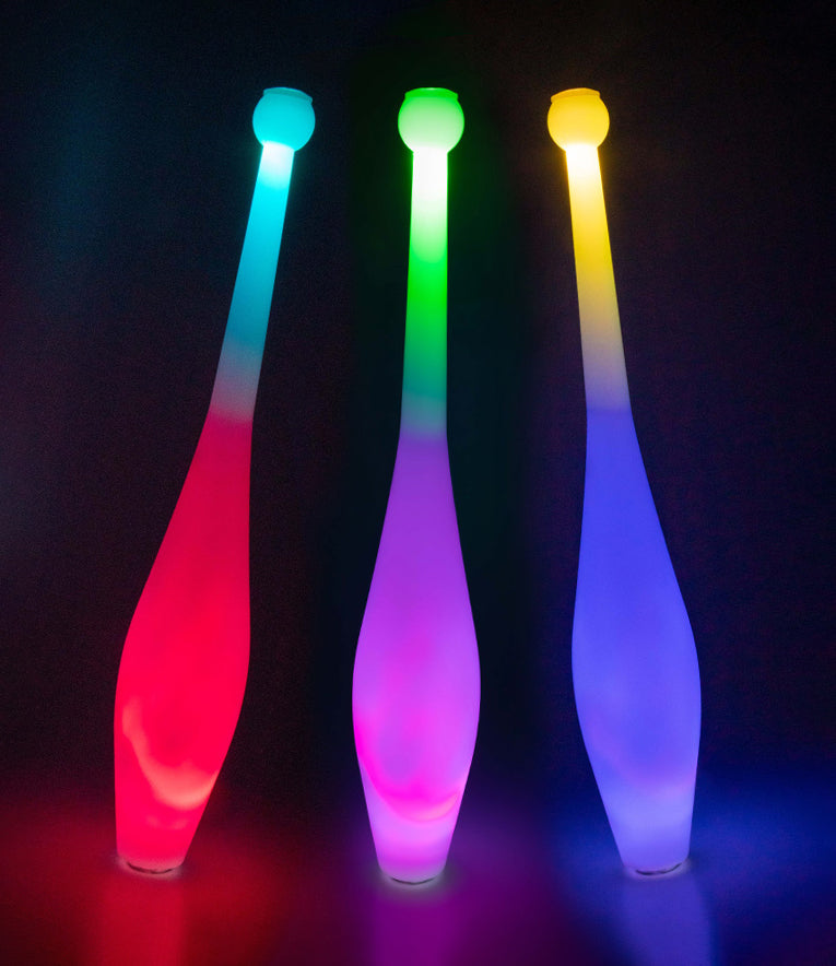 Three Juggle-Light LED One Piece Multi-light Juggling Clubs glowing in the dark