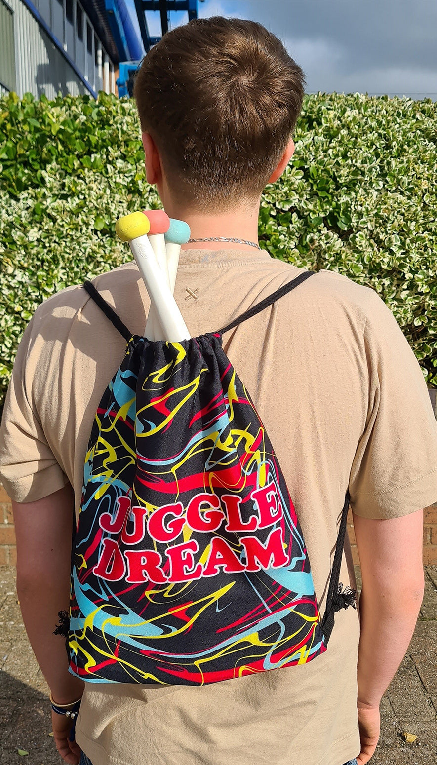 Juggle Dream drawstring bag on man's back