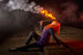 Girl with burning Juggle Dream Fire Eating Stick making fire trick