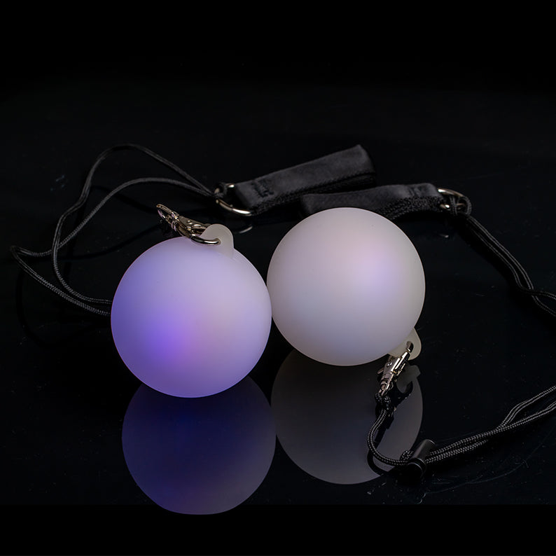 A pair of Oddballs Soft Strobe LED Glow Poi On Black String in black background