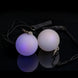 A pair of Oddballs Soft Strobe LED Glow Poi On Black String in black background