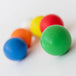 Green Bouncing Ball with other colours balls blurred in the background