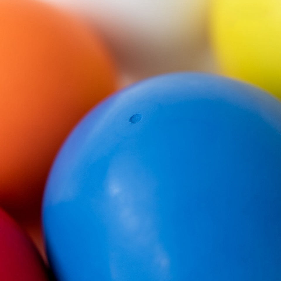 Close-up of blue Bouncing Ball with other colours balls blurred in the background