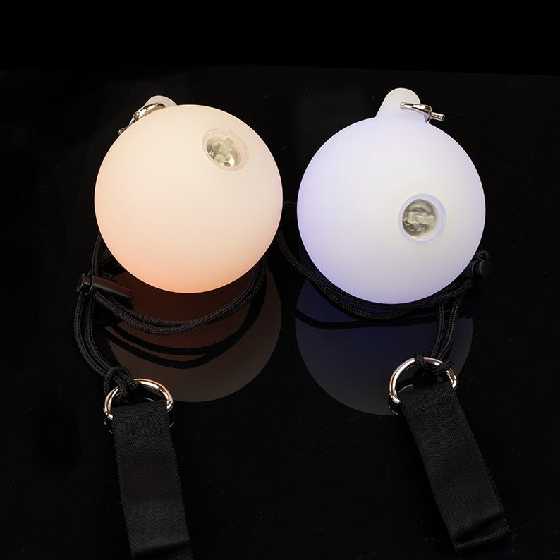 A Pair of Oddballs Soft Strobe LED Glow Poi On Black String in black background