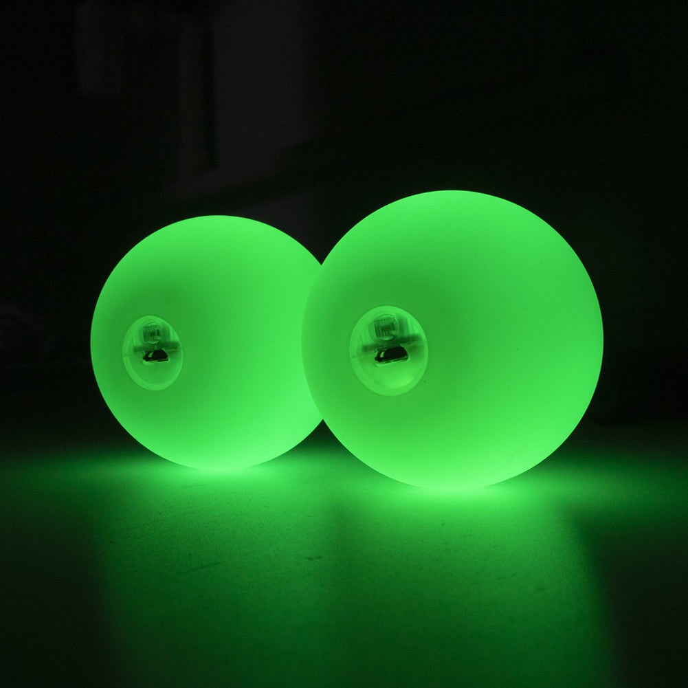 A pair of 70mm Multi function Pro Poi glowing in green colour; view from the side