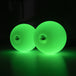 A pair of 70mm Multi function Pro Poi glowing in green colour; view from the side