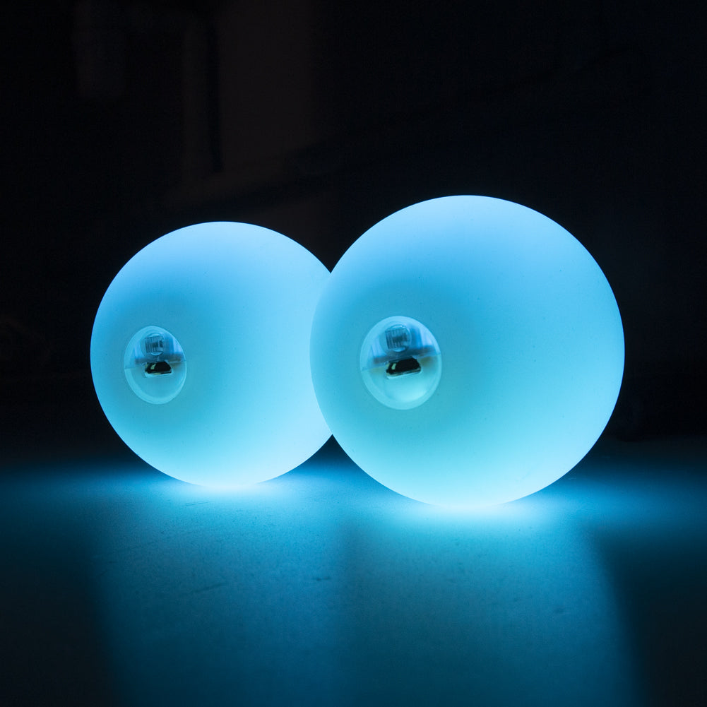A pair of 70mm Multi function Pro Poi glowing in blue colour; view from the side