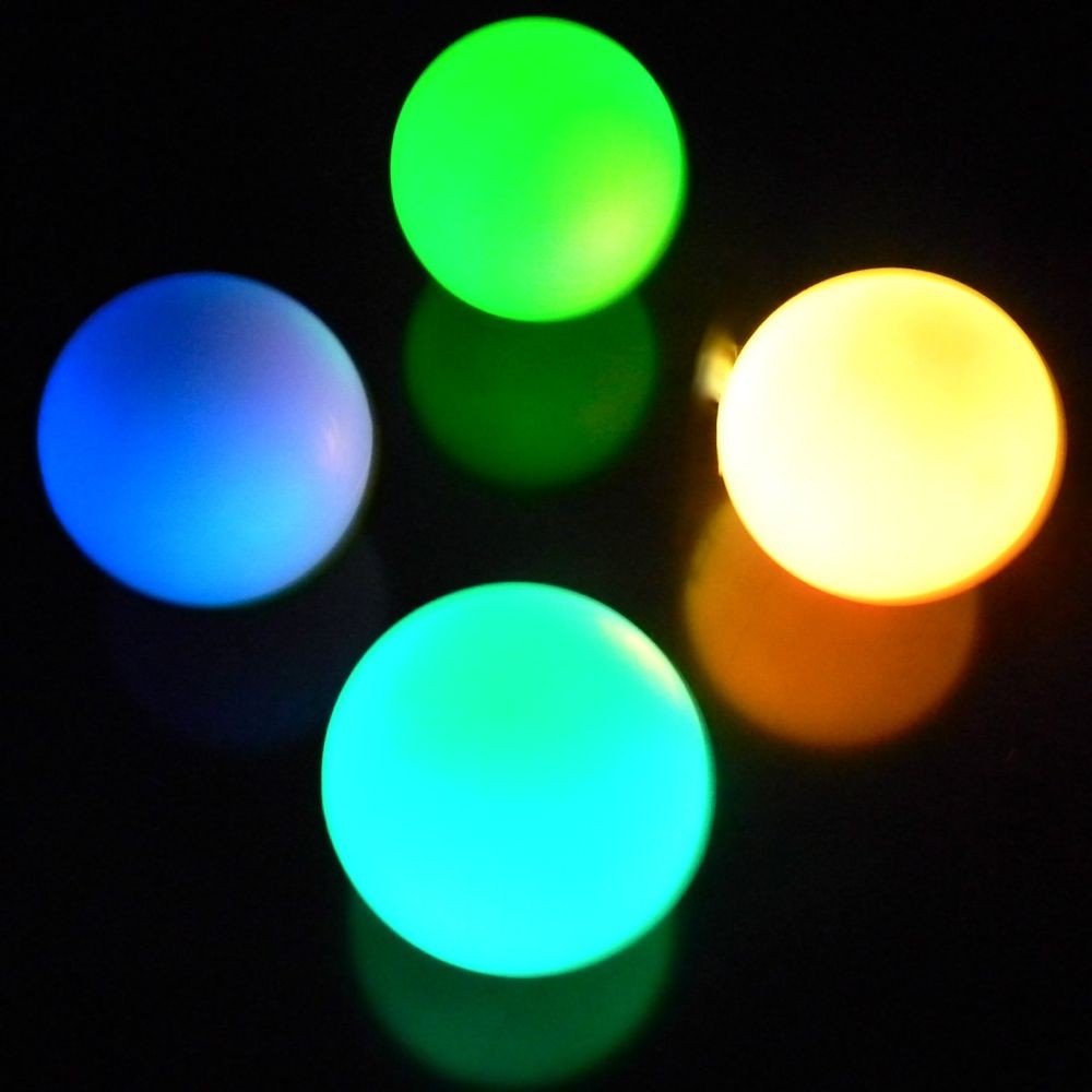 Four balls glowing in various colours in slow fade mode