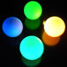 Four balls glowing in various colours in slow fade mode