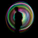 Spinning Juggle Dream Aurora Pro LED Hoop with men shadow in background