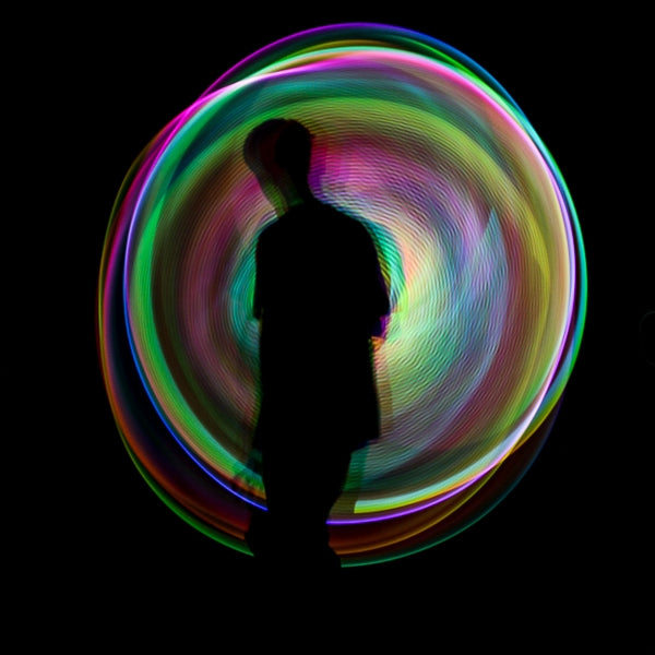 Spinning Juggle Dream Aurora Pro LED Hoop with men shadow in background